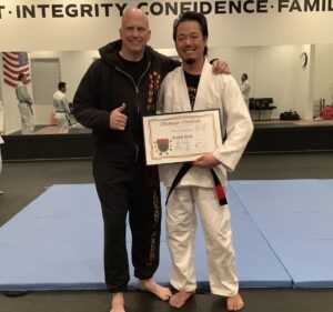 Thee receiving his Blackbelt in 2023
